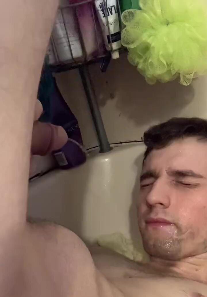 pissing on his own face in the bathtub