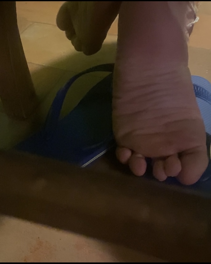Boy candid feet under the chair and shoeplay