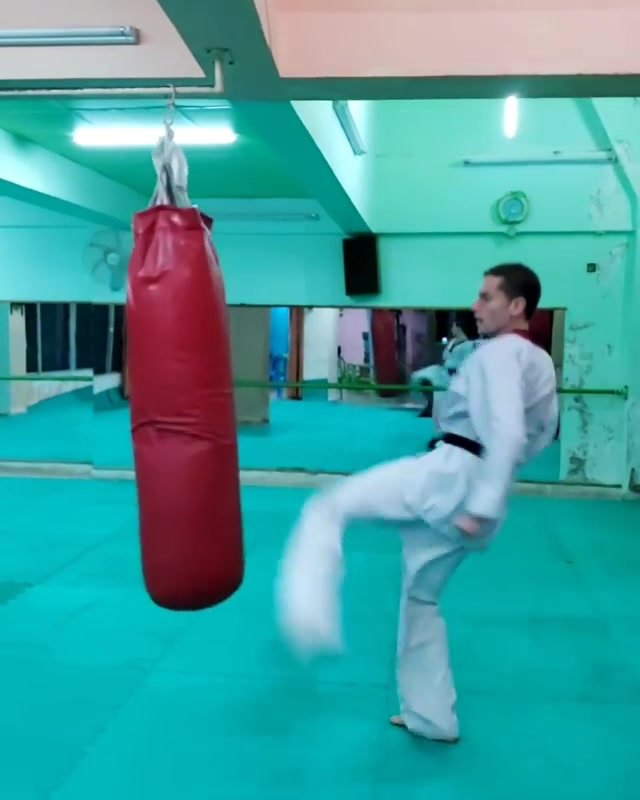 Taekwondo man demos kicks