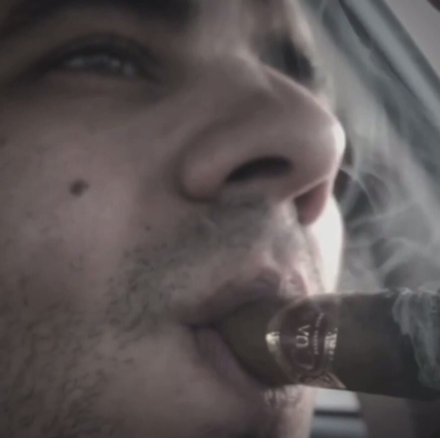 Close up young cigar smoker