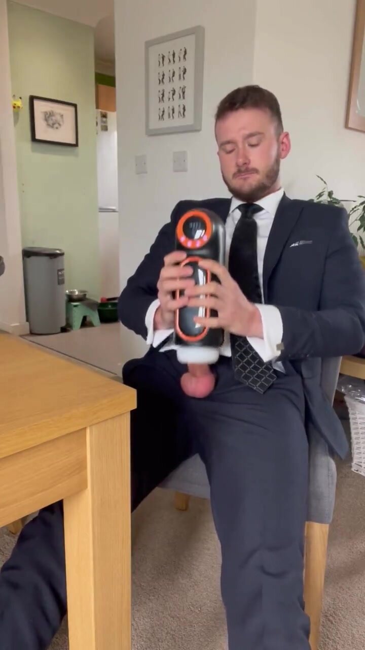 suited guy busts his load