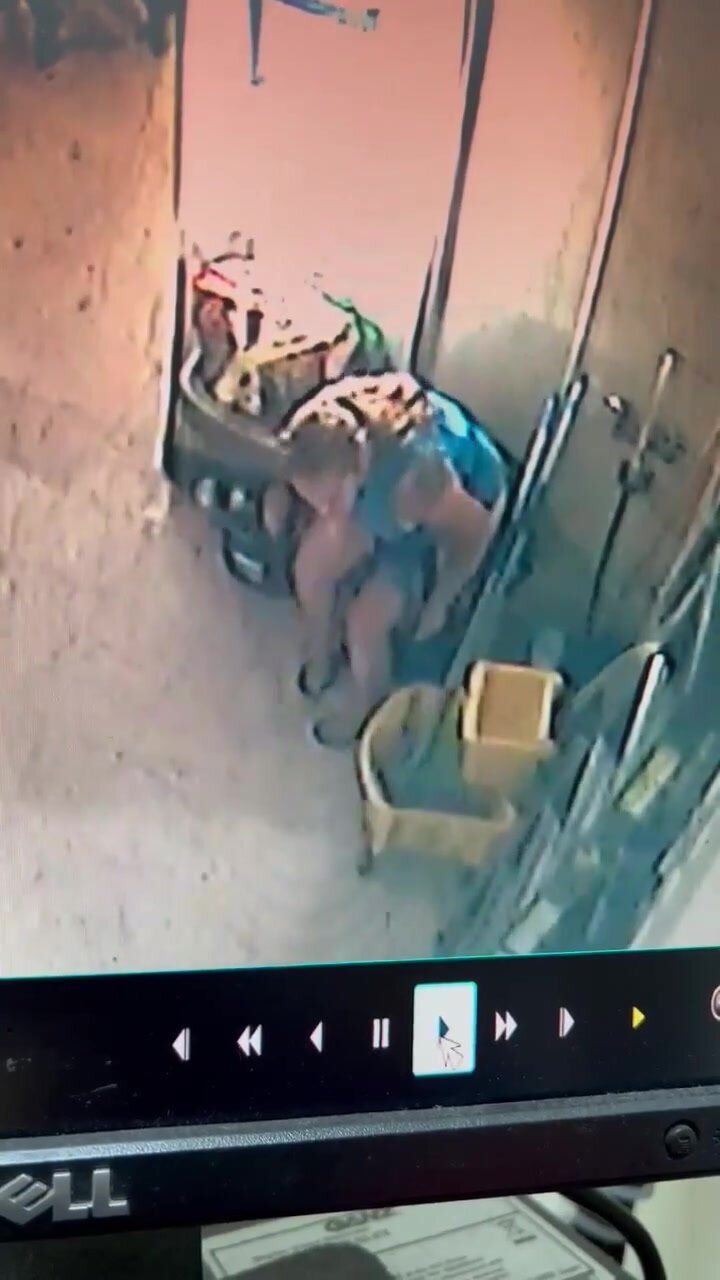 Woman pissing in trash can