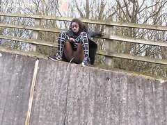 Ebony Savvy Pees off a bridge