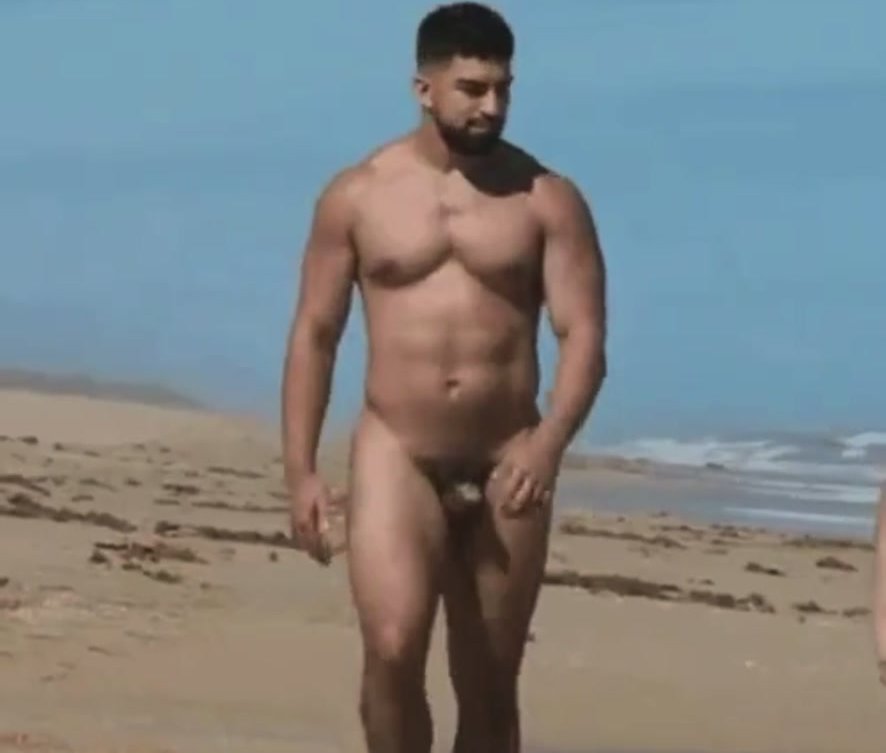 Sexy hunk walking naked at the beach