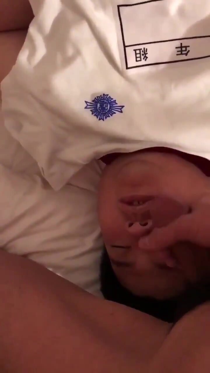 Sleeping asian chub get a load on his face