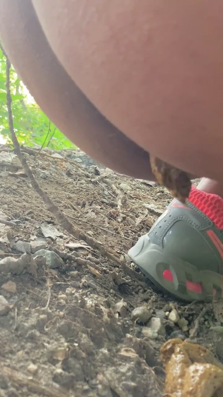Girl pooping out in the woods