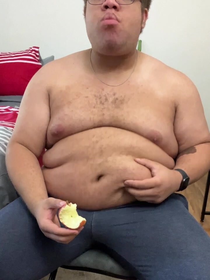 Fat guy eating a apple and jiggling his belly