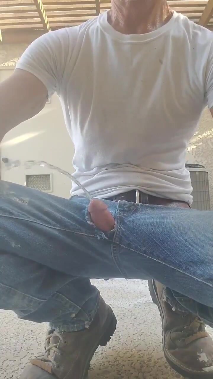 Redneck pisses through hole in his jeans.