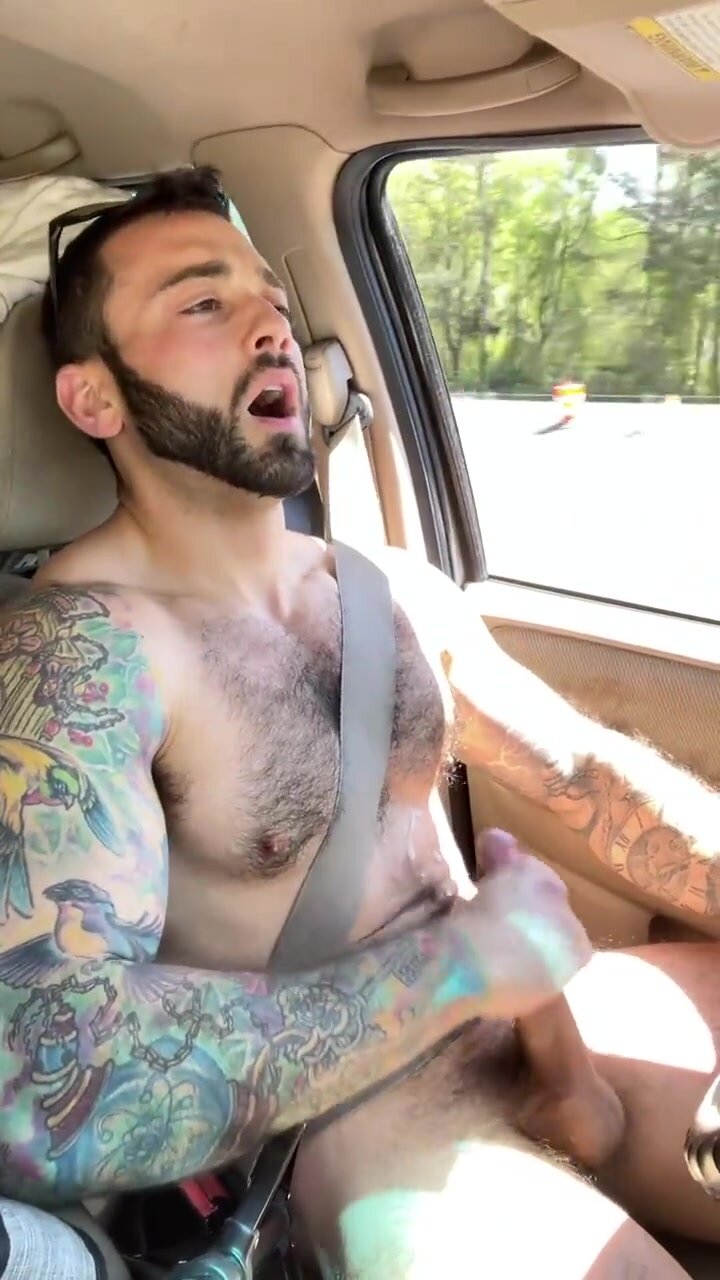 Handsome tattooed hunk jerks off and cums while driving