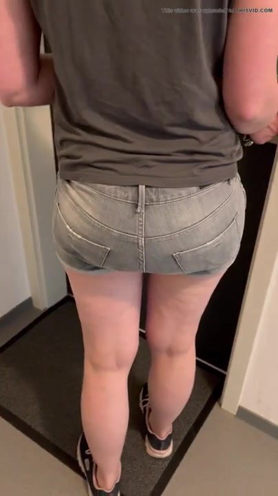 Girl in hotpants wearing a leaky diaper