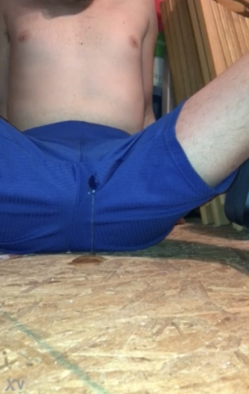 Teen boy wets his blue shorts