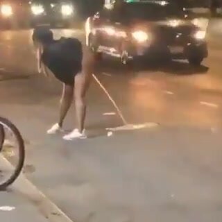Drunk ebony girl pissing in the street