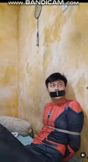 Indonesian boy gagged with spiderman costum