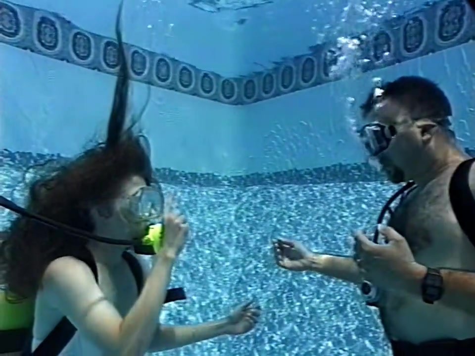 Scuba man and woman tangled in net underwater