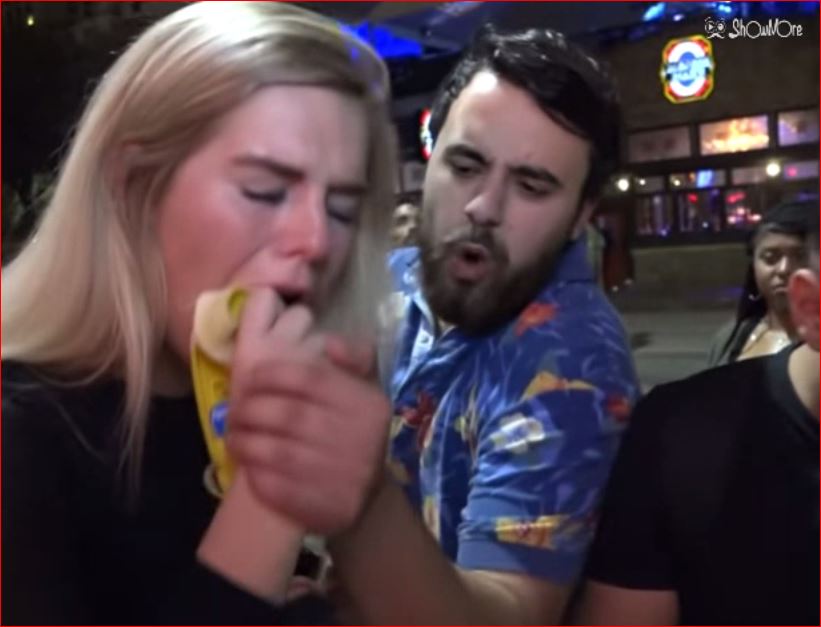 Fantastic girl swallows a banana in the street