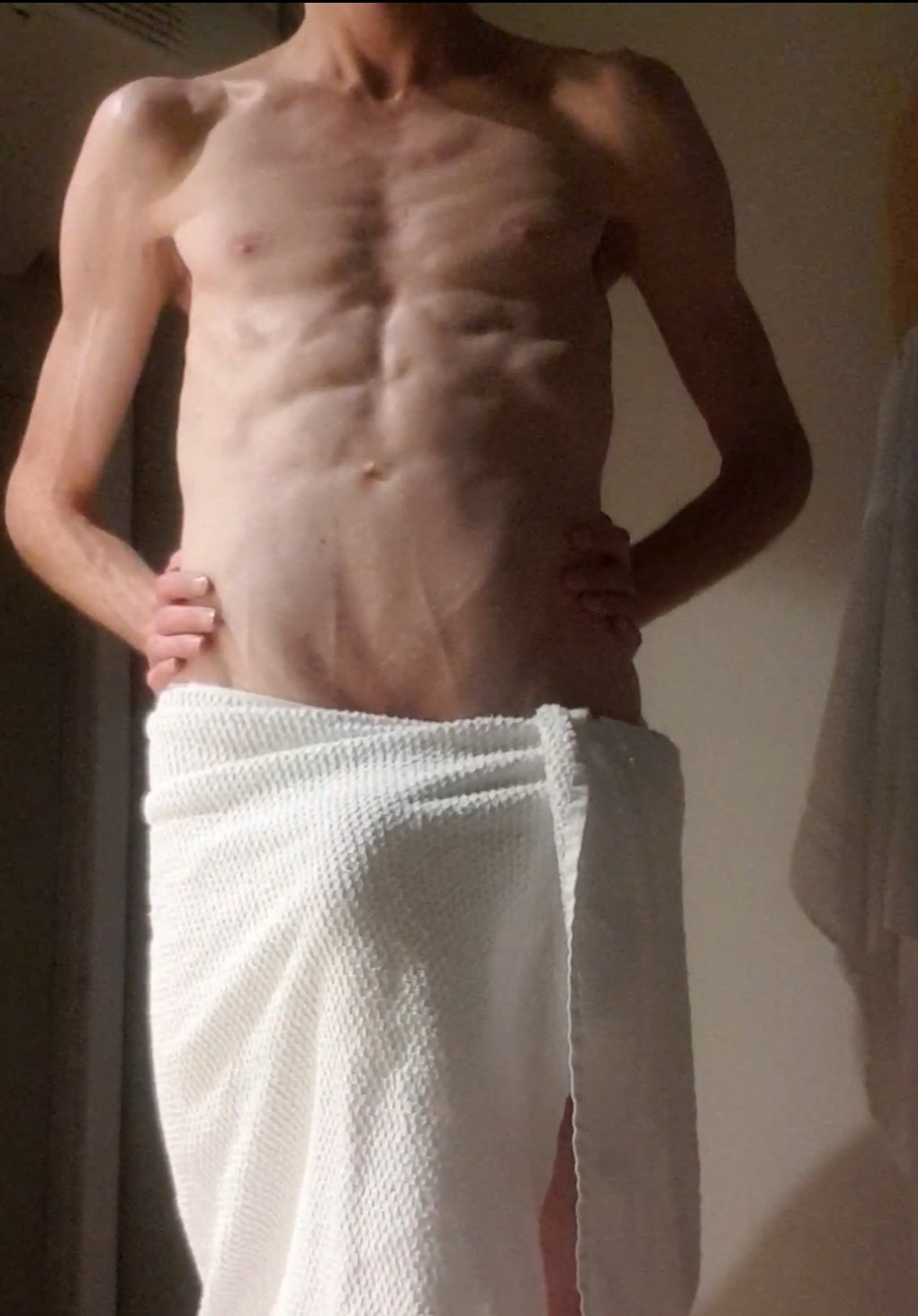 Skinny muscular boy in towel