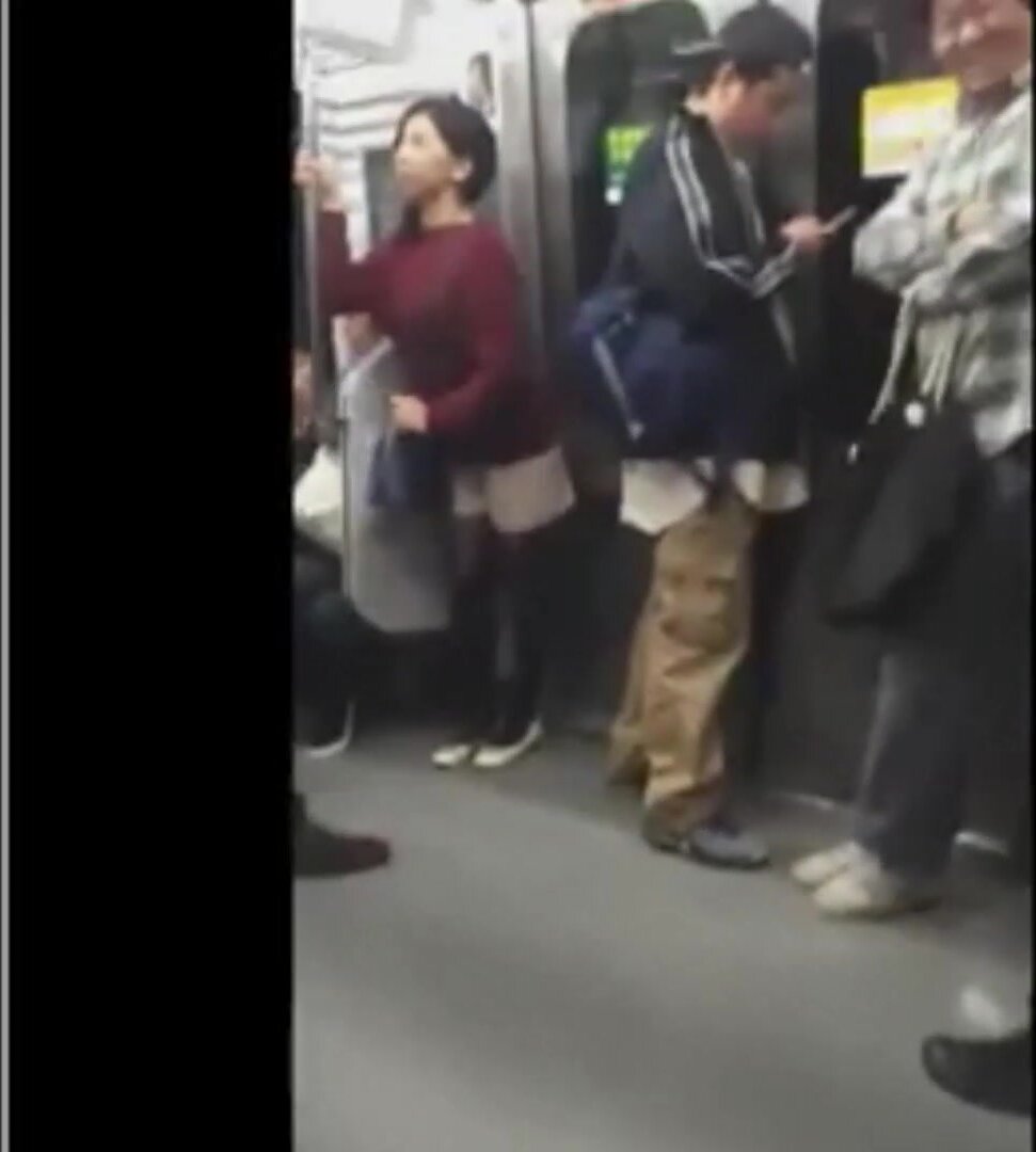 Japanese woman holding pee on train