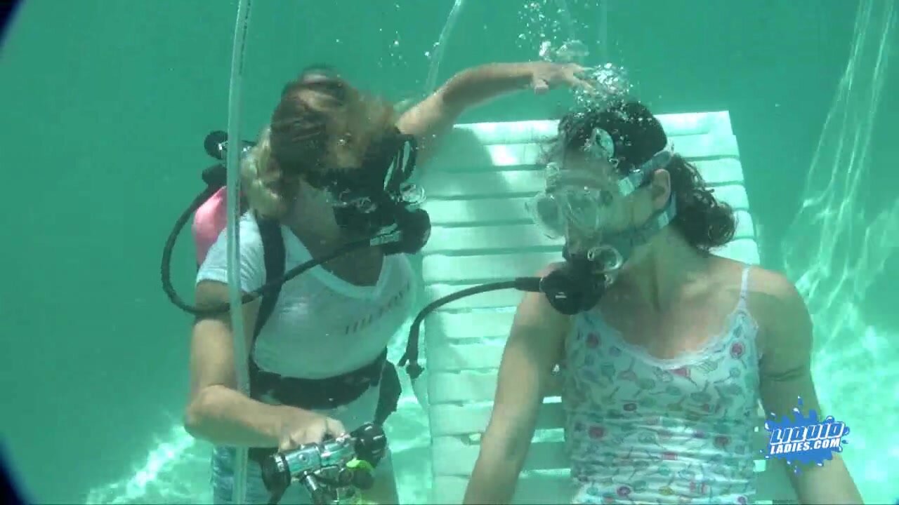 Scuba woman tied in chair underwater