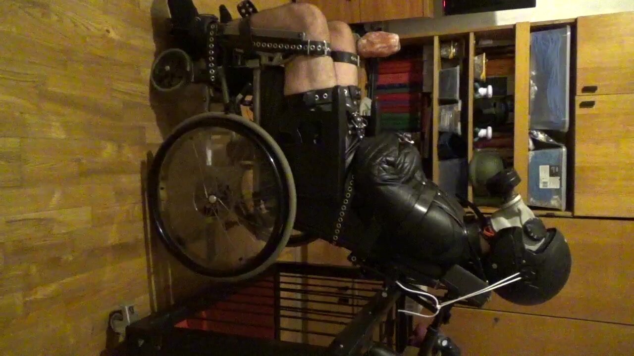 Straitjacketed slave is restrained to a wheelchair - video 6