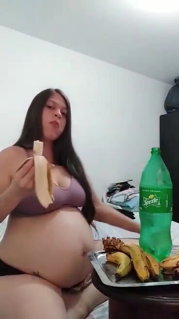 Pregnant woman belly stuffed with banana and sprite