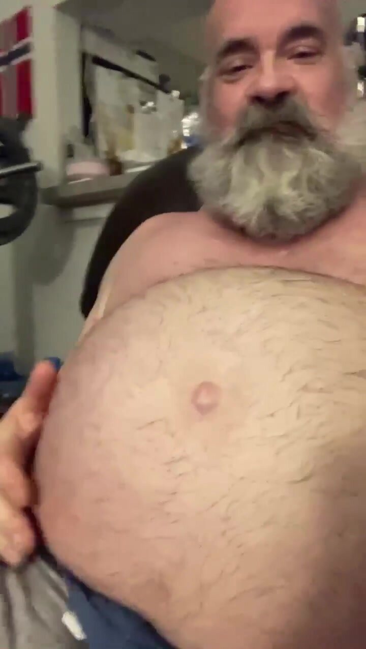 Old man showing off his gut