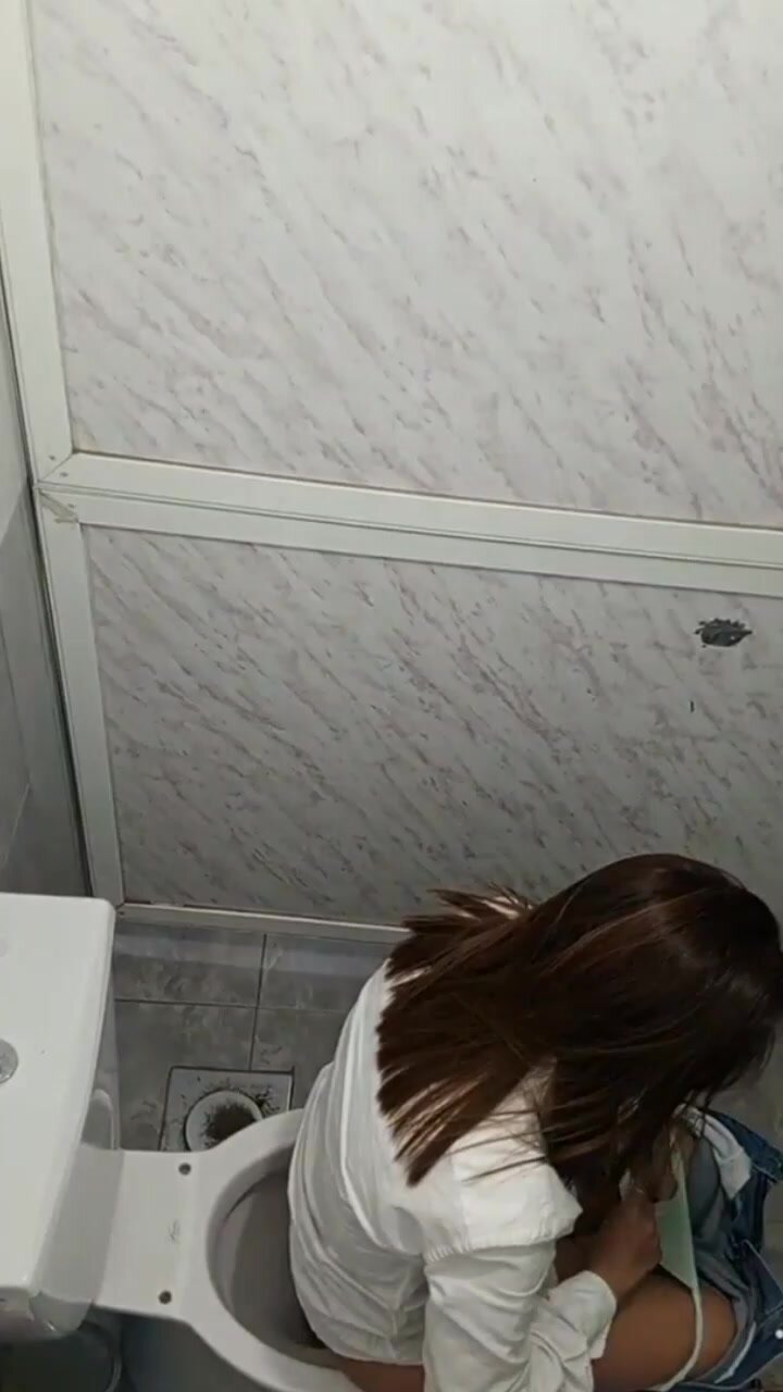 Spying girl pooping on toilet from above