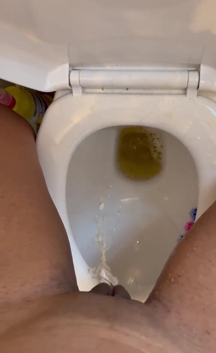 Puffy pussy stands directly over the toilet pissing