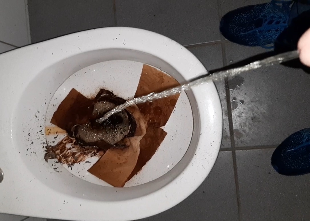 pissing in a well used toilet in an abandoned building