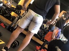 Hetero man squeeze his sweaty cheeks in the gym