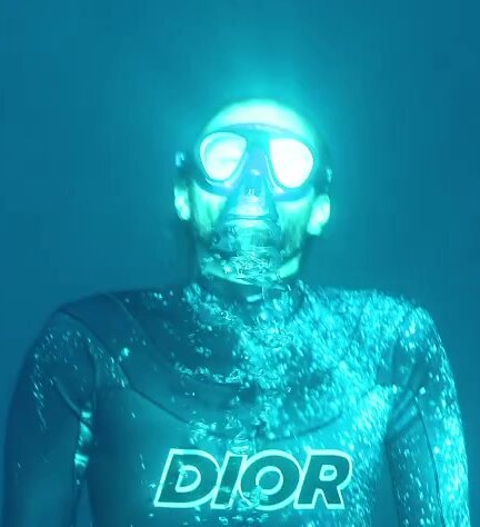Guillaume barefaced underwater in bulging wetsuit