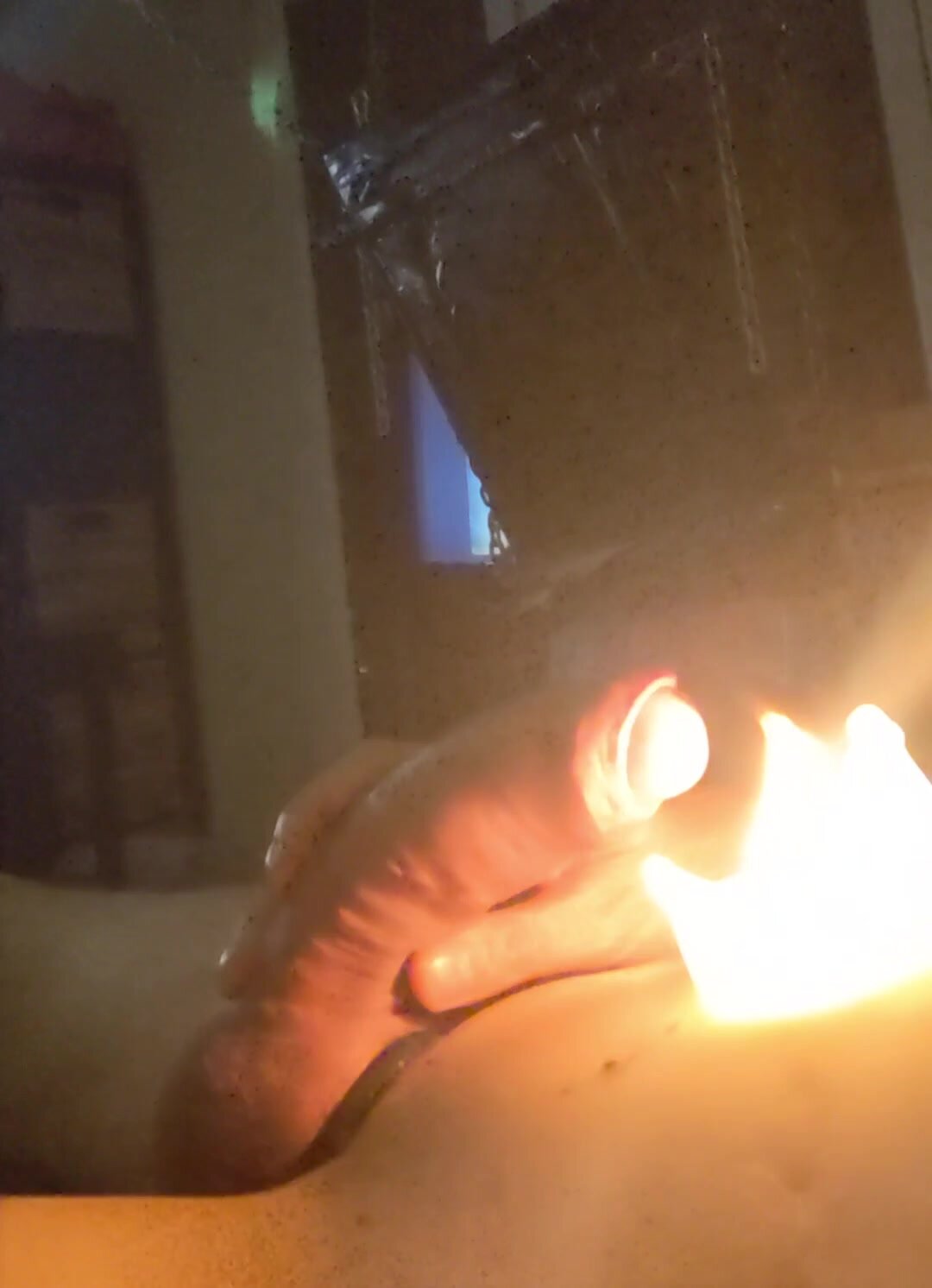 Jerking off dick over candle flame
