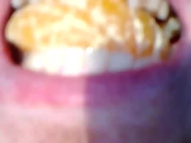 Close up of a hot guys mouth as he swallows oranges