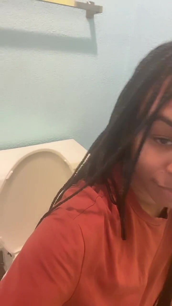 Cute ebony films sitting on the toilet hissing