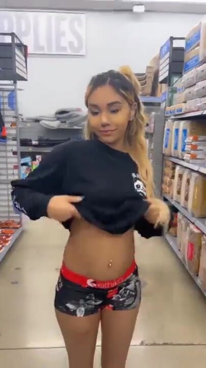 Adorable mixed cutie flashes her teen tits in store