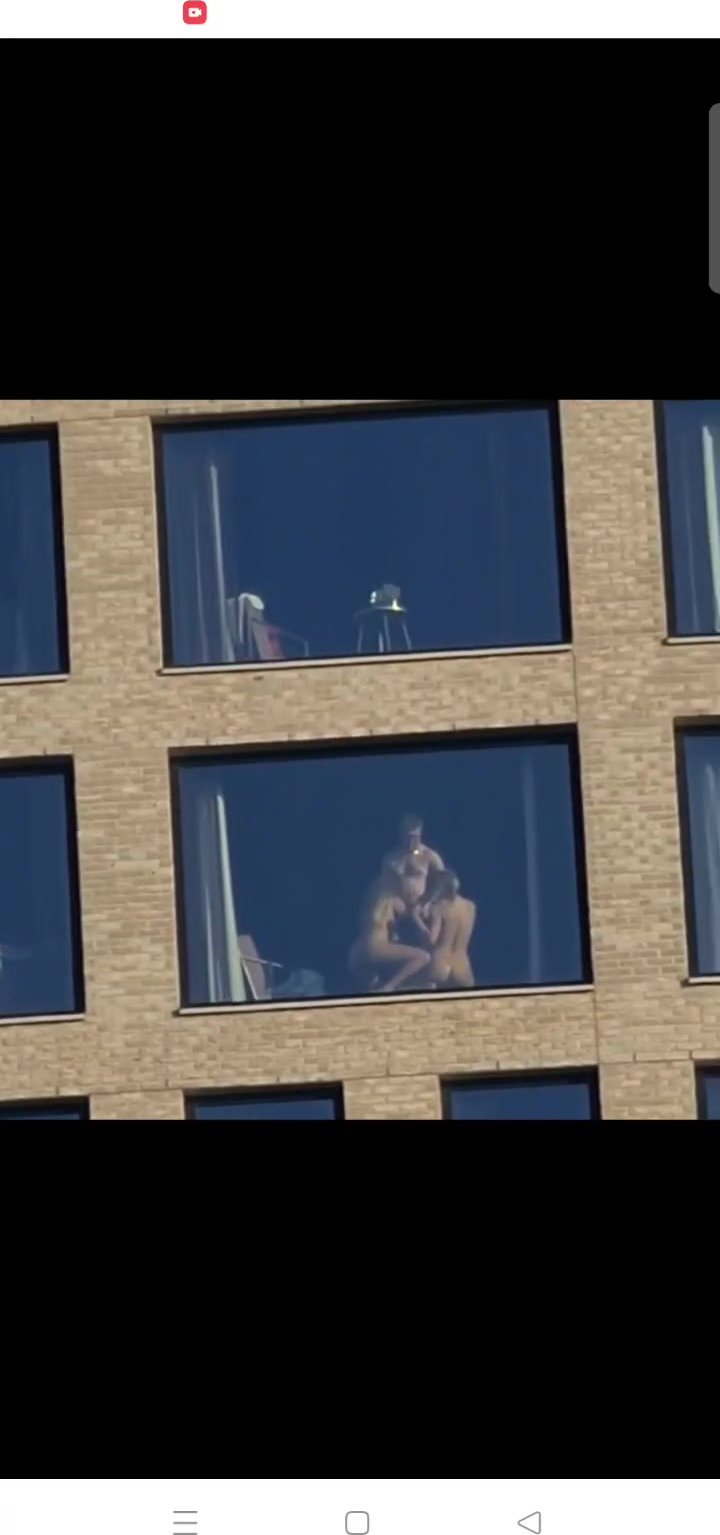 2 woman 1 men before window in Amsterdam