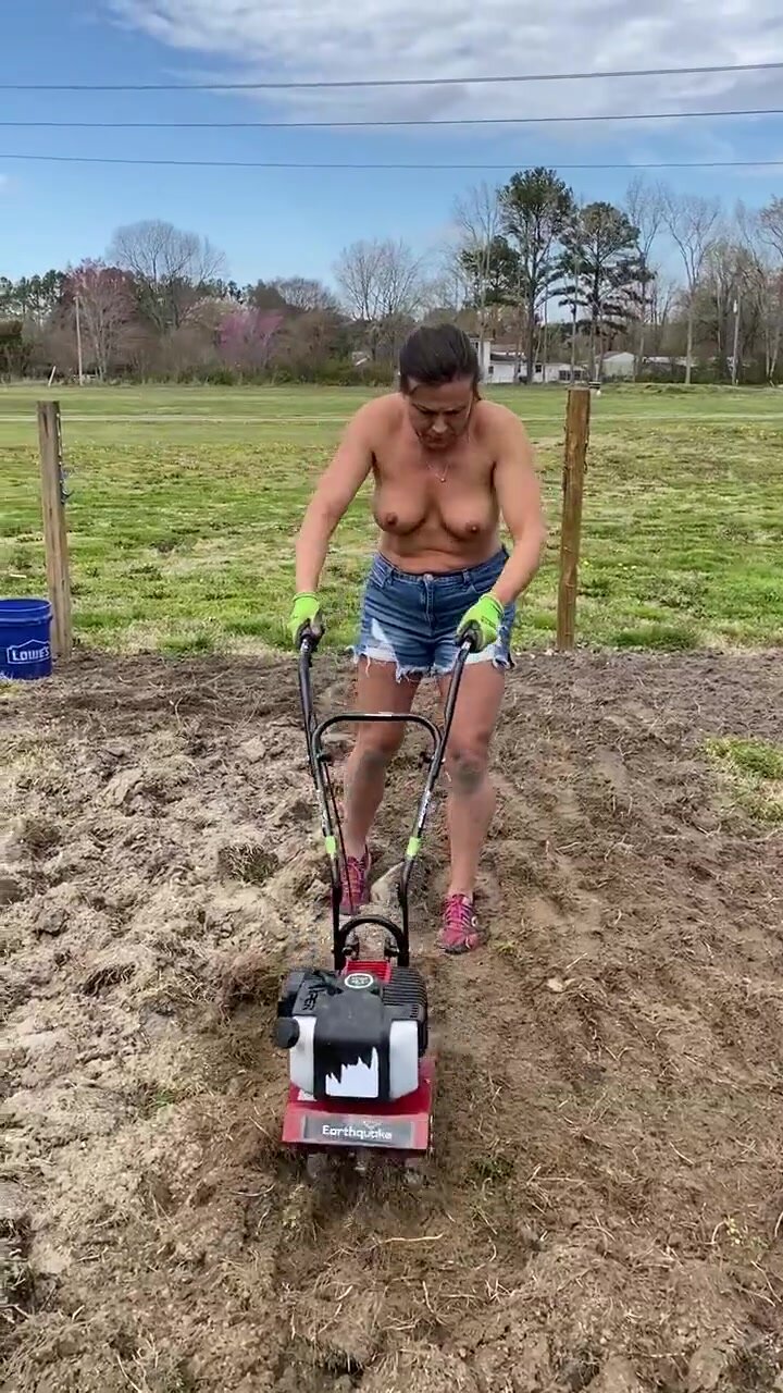 Milf farmer prepares the soil with her tits out