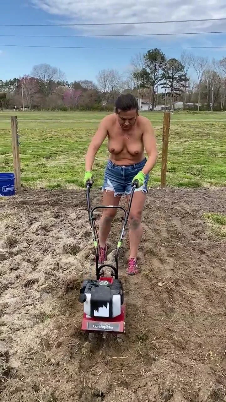 Milf farmer prepares the soil with her tits out - ThisVid.com