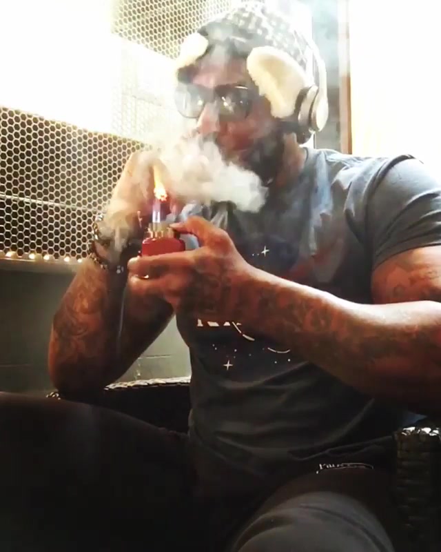 Hot tatted man smoking a good fat cigar