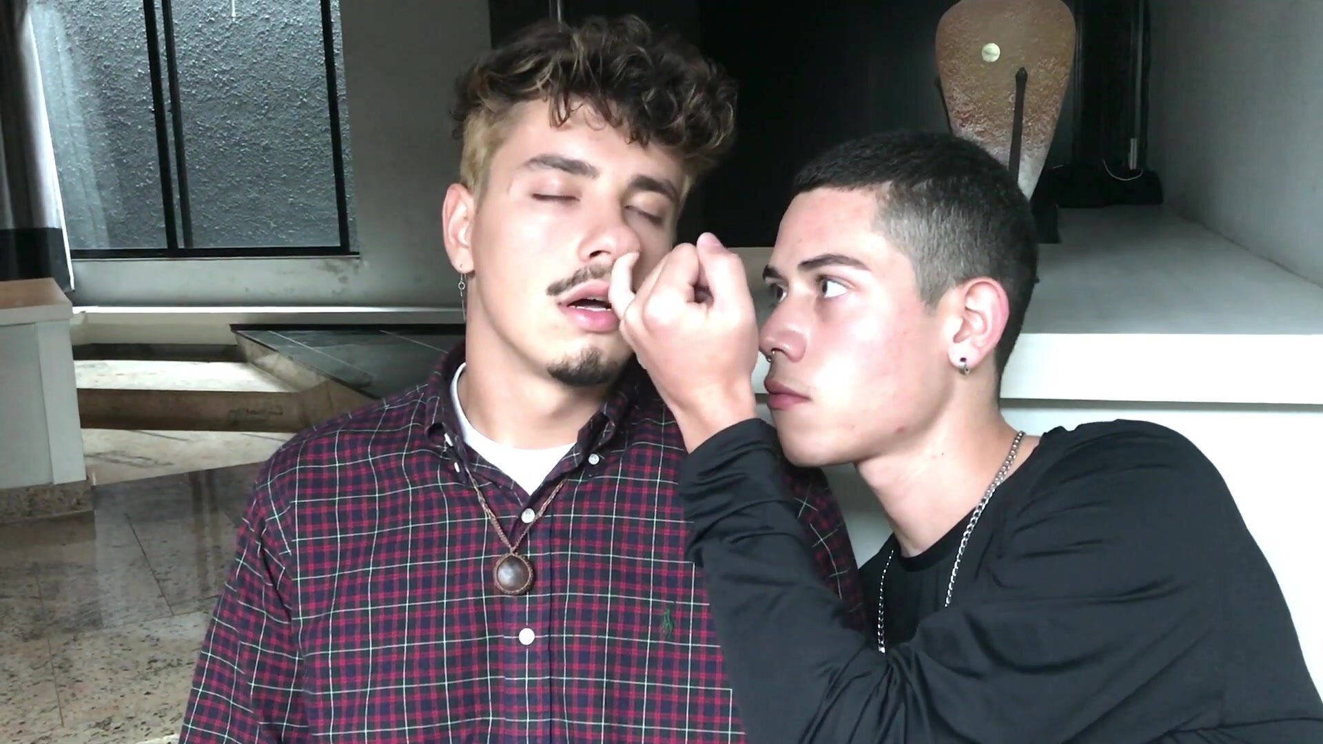 Two latin guys picking nose