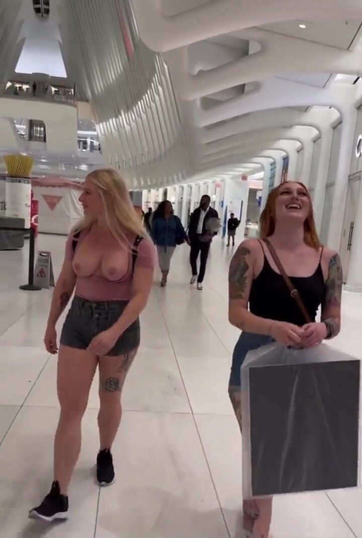 Friends walk through the mall together, 1 with tits out