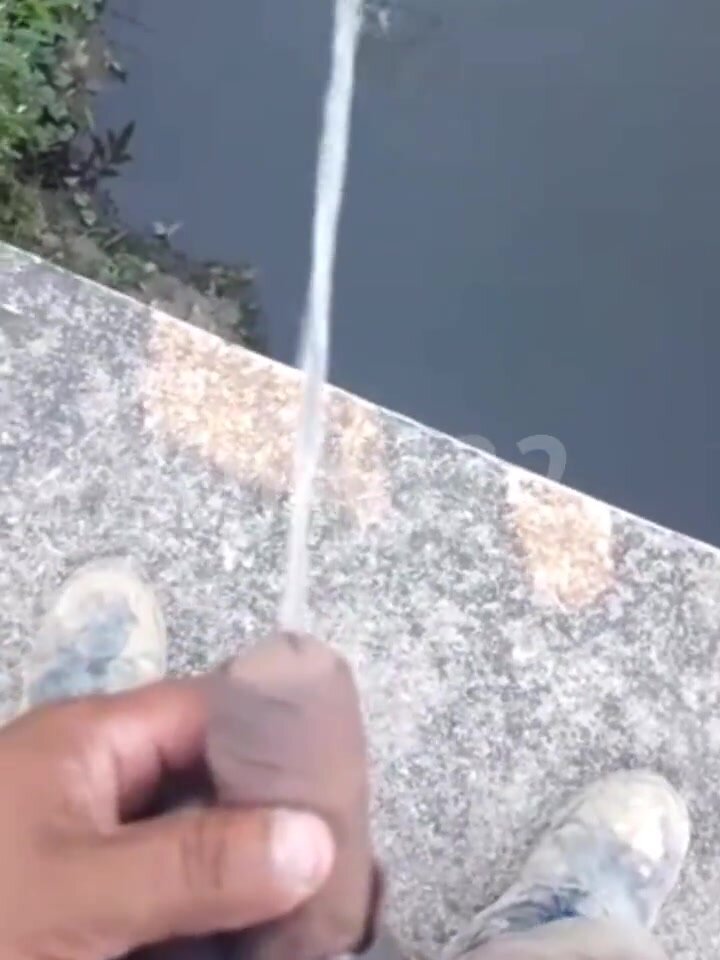 Mexican man pissing off a bridge on video call