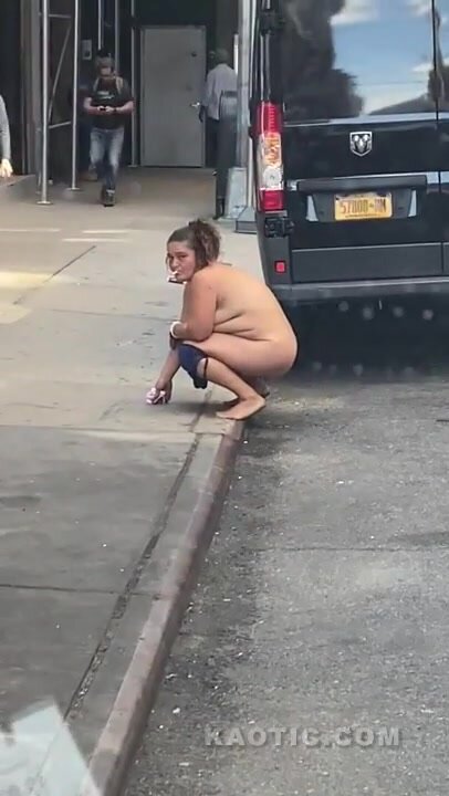 Homeless woman pissing in street