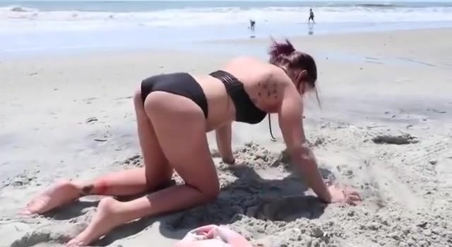 para girl crawling on beach