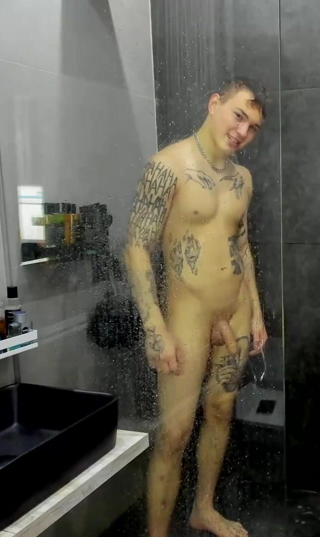 young tattoo guy showering