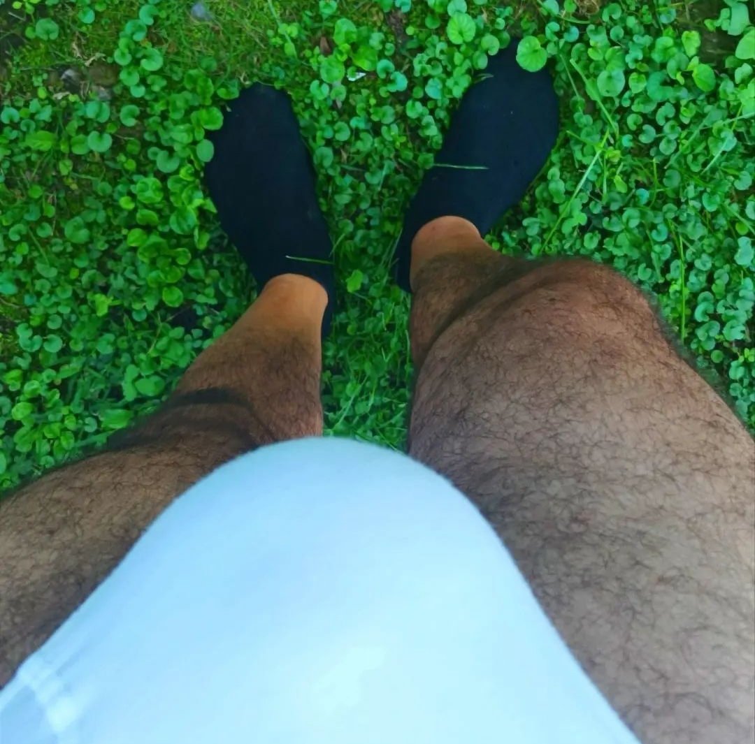 My bulge and my socked feet in the grass