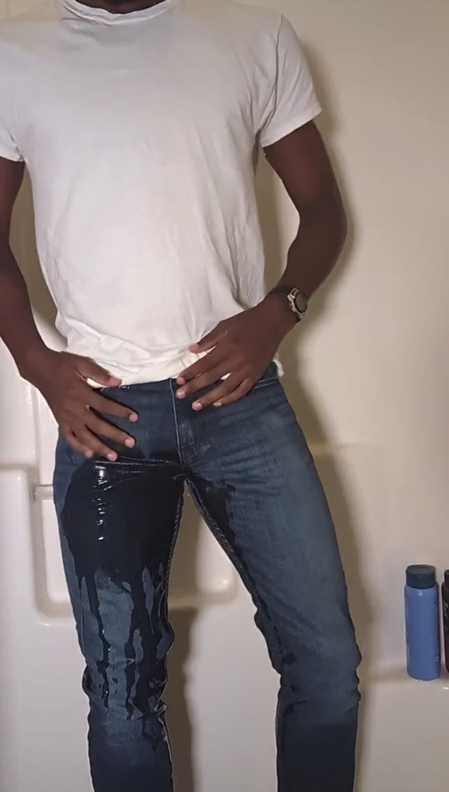 Young guy pissing his blue jeans