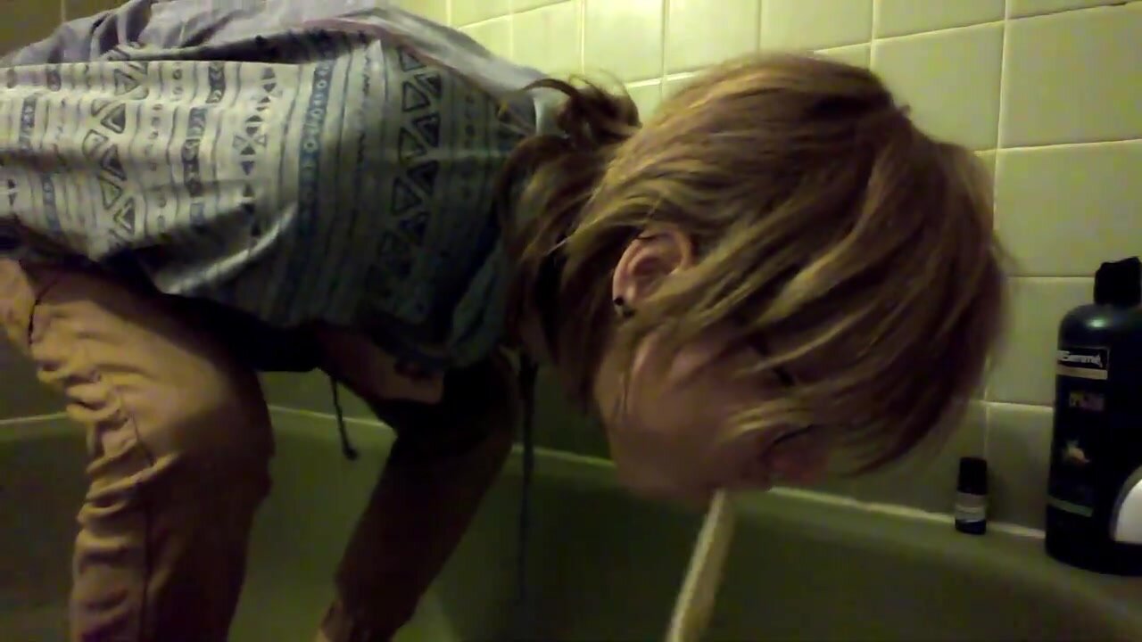 bulimic girl vomiting in tub