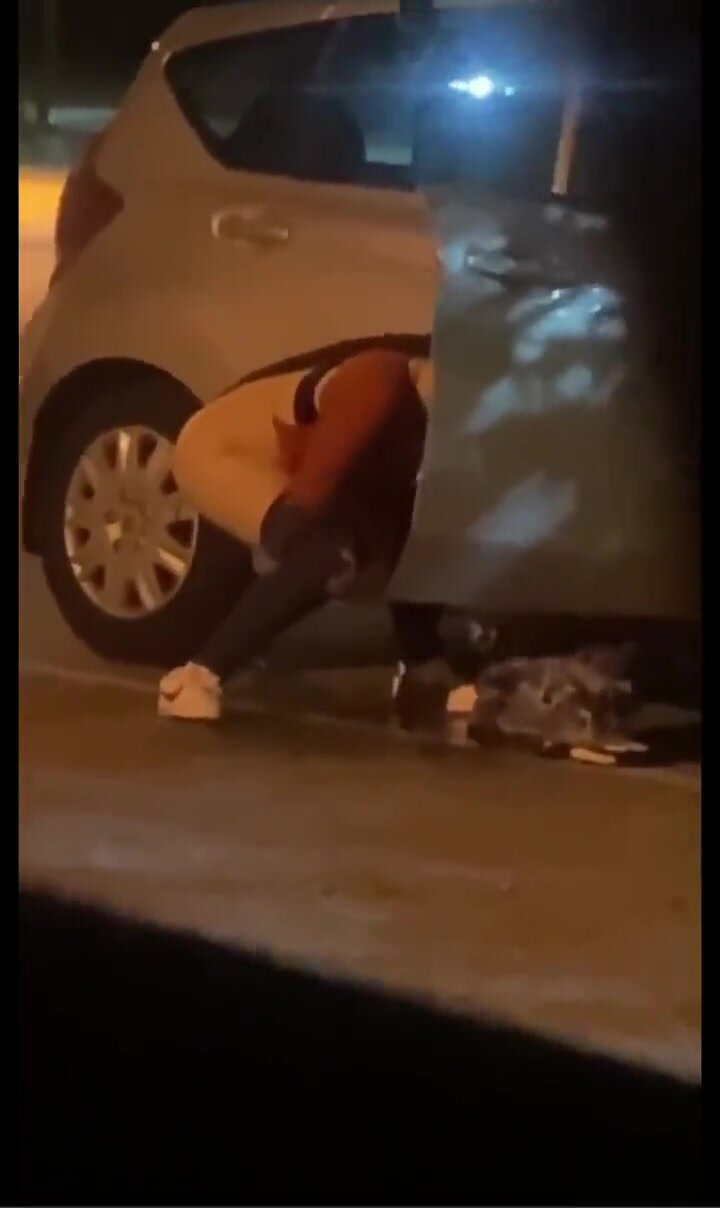 Sexy babe takes a leak outside car door in prking lot