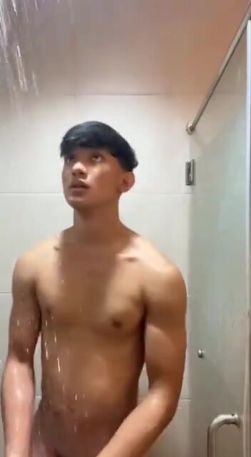 Handsome asian hunk taking shower