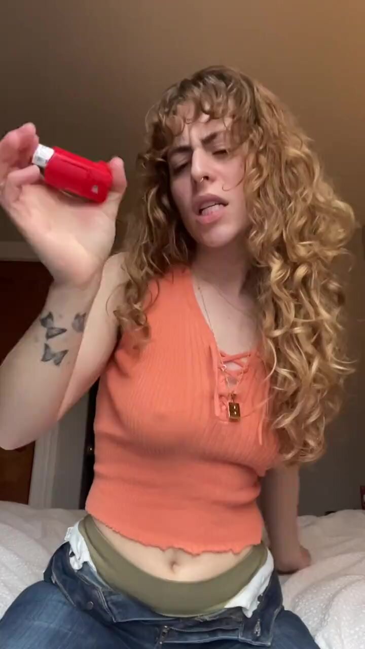 Sexy girl using her asthma inhaler